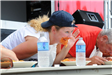 Woman Looking up from Her Plate at the Spaghetti Eating Contest