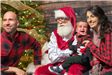 A Family Posing with Santa Claus